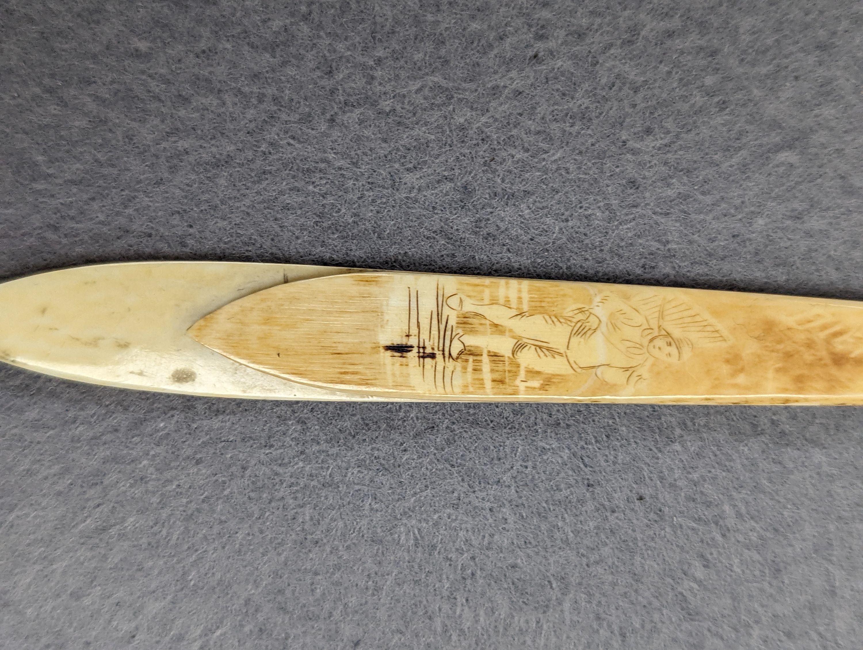 A pair of 19th century ivory balm pots, 3.75cm., a smallDieppe triptych figure, 6.5cm. a Meiji tiger brooch and a Dutch page marker.